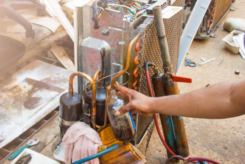 Close-up of a generic service model checking wiring and controls inside HVAC equipment