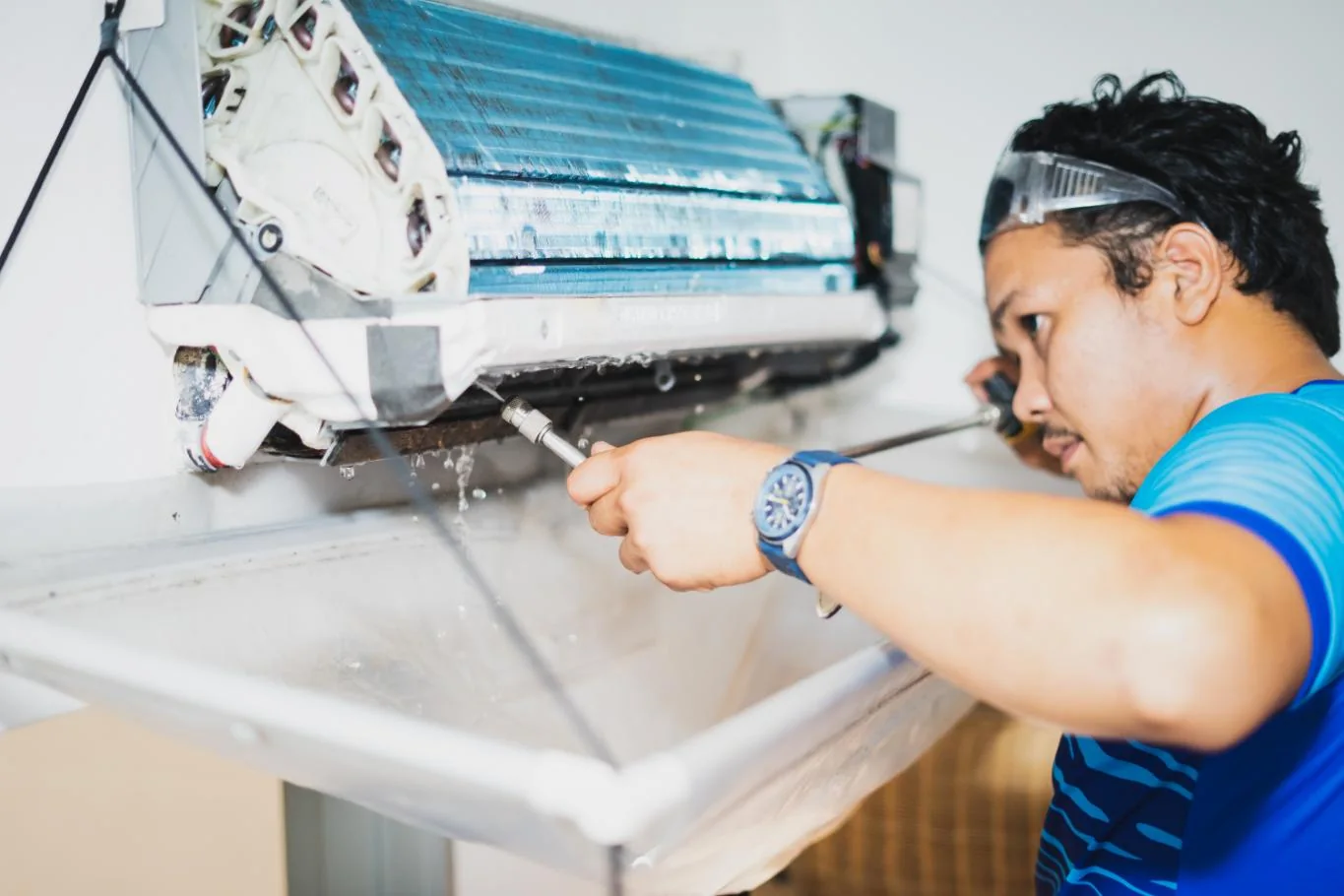 Generic service model cleaning an opened wall-mounted air conditioner indoors