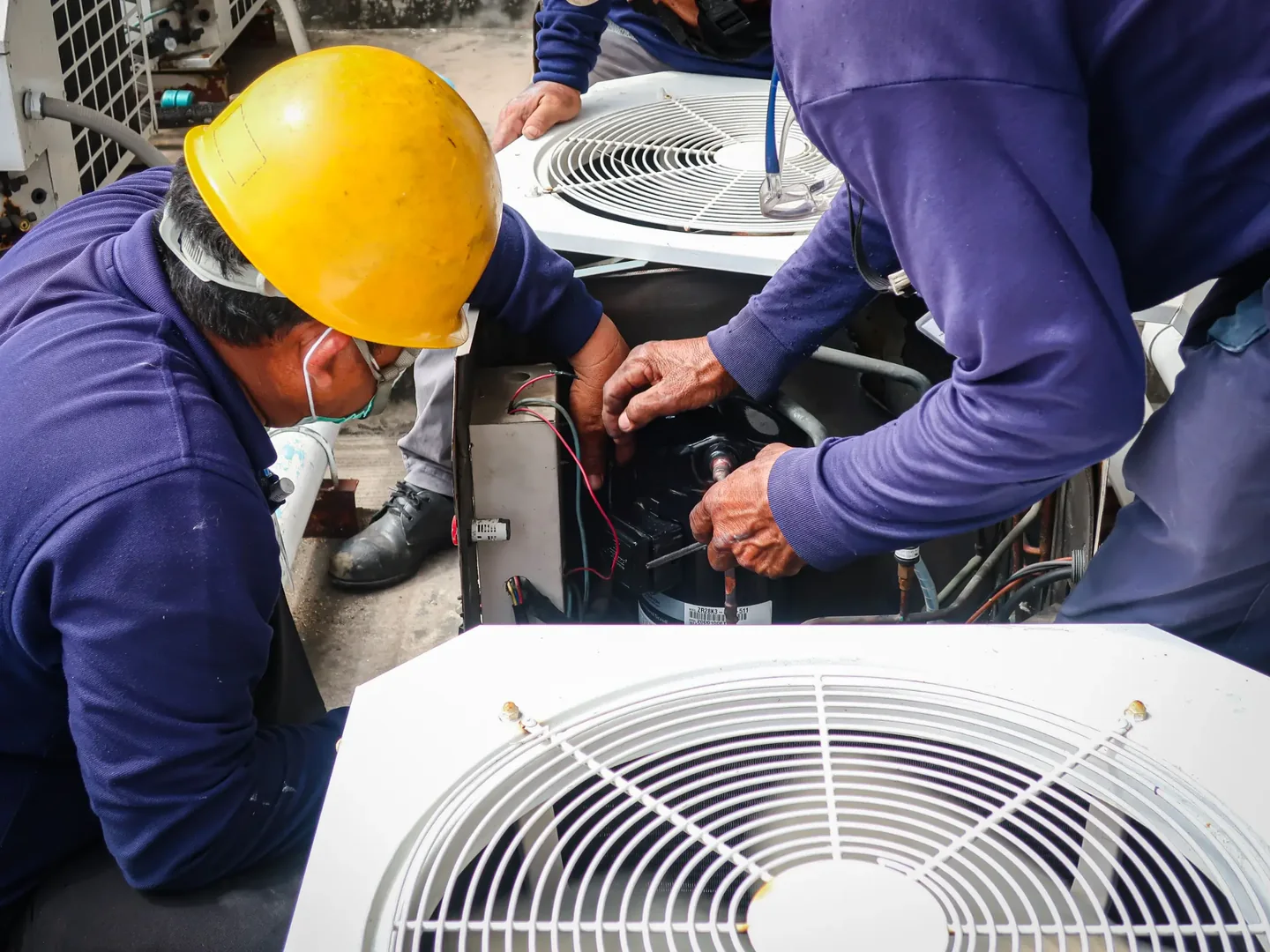 Two generic service models work on an open outdoor air-conditioning condenser